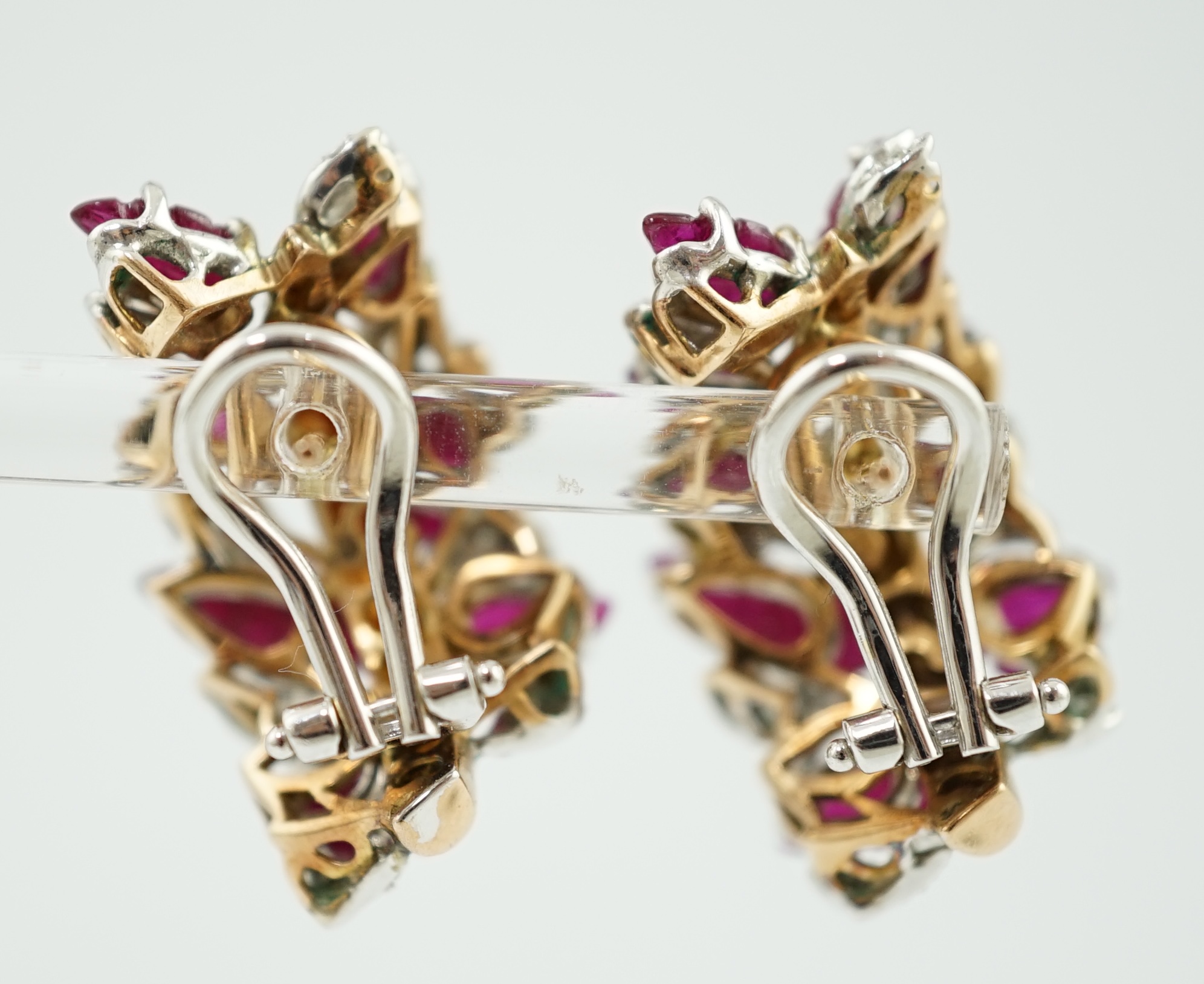 A modern pair of 18k, ruby and diamond cluster set demi-lune earrings
